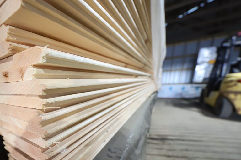 A large bundle of premium tongue-and-groove pine boards for interior finishing.